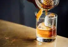 liquor pouring on clear shot glass